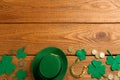 Leprechaun`s hat and St. Patrick`s day decor on wooden background, flat lay. Space for text Royalty Free Stock Photo