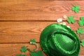 Leprechaun`s hat and St. Patrick`s day decor on wooden background, flat lay. Space for text Royalty Free Stock Photo