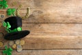 Leprechaun`s hat and St. Patrick`s day decor on wooden background, flat lay. Space for text Royalty Free Stock Photo