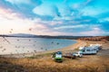 Lerissos, Greece, 25/06/2019: Motorhome vehicles parked on the beach with beautiful panoramic view on the bay and cloudy colorful Royalty Free Stock Photo