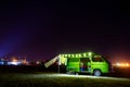 Lerissos, Greece, 25/06/2019: Young girl watching the starry sky from old timer camper van parked on the beach with decorative