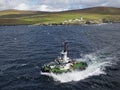 The Lerwick Pilot Boat the Knab, approaches a Vessel ready to board the Pilot in heavy seas in Bressay Sound