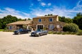 Les Imberts, France - June 16, 2018. Two convertible vintage cars parked in front of typical french provence house