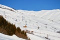 Les Sybelles ski domain in France - view of long chair lifts and pistes, on a blue sky day