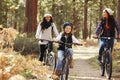 Lesbian couple cycling in a forest with their daughter Royalty Free Stock Photo