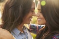Lesbian couple embrace touching noses, eyes closed, close up Royalty Free Stock Photo