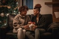 lesbian couple giving gifts and presents to each other, female gay lgbt homosexual african american marriage or black girlfriends