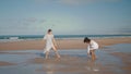 Lesbian couple having fun at ocean beach. Cheerful girls playing splashing water Royalty Free Stock Photo