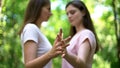 Lesbian couple holding hands, trustful same-sex relationships, lgbt rights