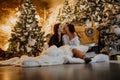 Lesbian couple kisses against background of Christmas decorations and retro car Royalty Free Stock Photo