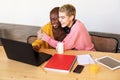 Girls drinking coffee and shopping online on laptop Royalty Free Stock Photo