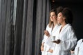 Lesbian couple relaxing and drinking tea in robes during wellness weekend Royalty Free Stock Photo