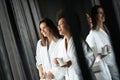 Lesbian couple relaxing and drinking tea in robes during wellness weekend Royalty Free Stock Photo