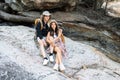 Lesbian couple relaxing together on rock at a hiking trail While traveling together on a hiking trail Royalty Free Stock Photo