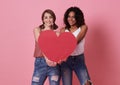 Lesbian couple standing and hand holding red heart for valentine`s day