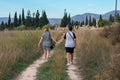 A lesbian couple is walking through the meadow