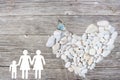 Lesbian Family on wooden background with white stones heart and blue butterfly
