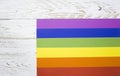 Lesbian, Gay, Bisexual and Transgendered Flag The rainbow pride flag of the LGBT organization, on a white wooden board with space