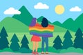 Lesbian in love covered with rainbow colored flag in nature