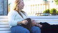 Lesbian lying on the bench and the knees of her girlfriend in the park. Media. Lesbian woman kissing another girl on her Royalty Free Stock Photo