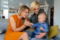 Lesbian mothers with adopted child. Happy homosexual family playing with her daughter Royalty Free Stock Photo