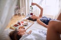 Lesbians laying, breakfast in bed, smelling the rose. lesbian,  romantic, breakfast in bed concept Royalty Free Stock Photo