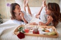 Lesbians sitting, breakfast in bed, talking, smiling, watching each other, in love. lesbian, couple, romantic, breakfast in bed Royalty Free Stock Photo