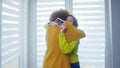 Lesbians waiting for baby Embracing in front of the window. Mutiracial relationship Royalty Free Stock Photo