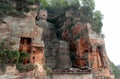 The Leshan Grand Buddha near Chengdu in China with smaller statues either side Royalty Free Stock Photo