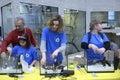 Lesson of aquarium husbandry. Girls arranging decorations in an empty aquarium