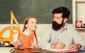 Lesson is finished. Discipline upbringing. Man bearded pedagogue study together with kid. Study is fun. School teacher