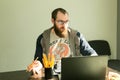 Lesson. Foreign language teachers discuss online quarantine lessons. A man in a classroom are sitting at a table near a computer