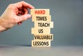 Lesson from hard times symbol. Concept words Hard times teach us valuable lessons on wooden blocks on a beautiful grey background Royalty Free Stock Photo