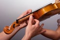 The lesson of playing the violin. Teacher helps to hold the violin Royalty Free Stock Photo