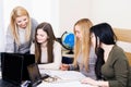 Lesson teacher school table computer business team workspace class mate group woman man room Royalty Free Stock Photo