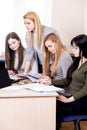 Lesson teacher school table computer business team workspace class mate group woman man room Royalty Free Stock Photo