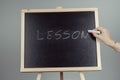 Lesson written in white chalk on a black chalkboard