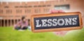 Lessons against students using laptop in lawn against college building Royalty Free Stock Photo