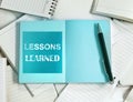 Lessons Learned concept with Manny empty notebook paper and note