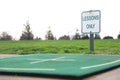 Lessons only sign on practice mat at driving range at golf course Royalty Free Stock Photo