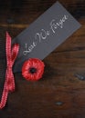 Lest We Forget, Red Poppy Lapel Pin Badge on dark recycled wood - vertical Royalty Free Stock Photo