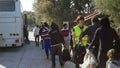 LESVOS, GREECE - NOV 5, 2015: Queue for boarding the bus to the refugee camp.