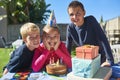 Let the birthday fun and festivities begin. Portrait of a group of young children enjoying an outdoor birthday party. Royalty Free Stock Photo