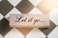 Let It Go wooden sign with a chess on background. Philosophy forgiveness concept