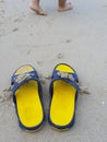 Let go word on the beach and yellow sandal