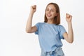 Let have some fun. Happy young woman dancing, girl enjoying party, raising hands up and celebrating, smiling carefree Royalty Free Stock Photo