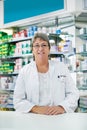 Let me attend to all of your wellness needs. Portrait of a happy mature woman working in a pharmacy.