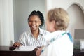 Let me check your booking. a senior woman checking in at the hotel. Royalty Free Stock Photo