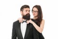 Let me help with bow tie. Woman elegant lady adjust male bow tie. Man bearded gentleman wear black tuxedo with bow tie Royalty Free Stock Photo