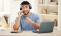 Let me help you with that. a young male call center agent working in an office. Royalty Free Stock Photo